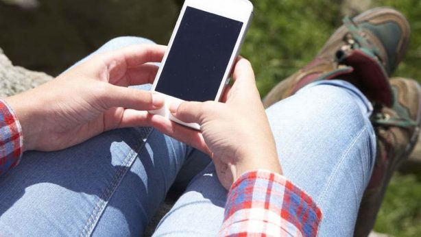 Teenage-Girl-Using-Mobile-Phone